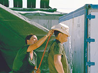 Corporal Vickie Naish surprises Corporal Dan Veelbehr with a hose. Photo: Department of National Defence IWC90-497