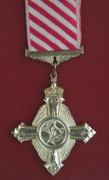 Air Force Cross.  A silver cross (1.625 inches across), shaped as a thunderbolt in the form of a cross, the arm terminates with a bomb. The cross is surmounted by another cross composed of aeroplane propeller blades, with the ends of the four blades enscribed with the Royal Cypher.