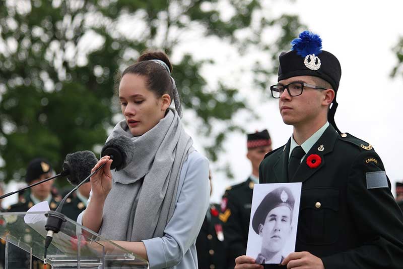 A Canadian youth delivers a presentation on a fallen soldier during a ceremony at Bretteville-sur-Laize Canadian War Cemetery in Normandy, France. Photo: VAC.