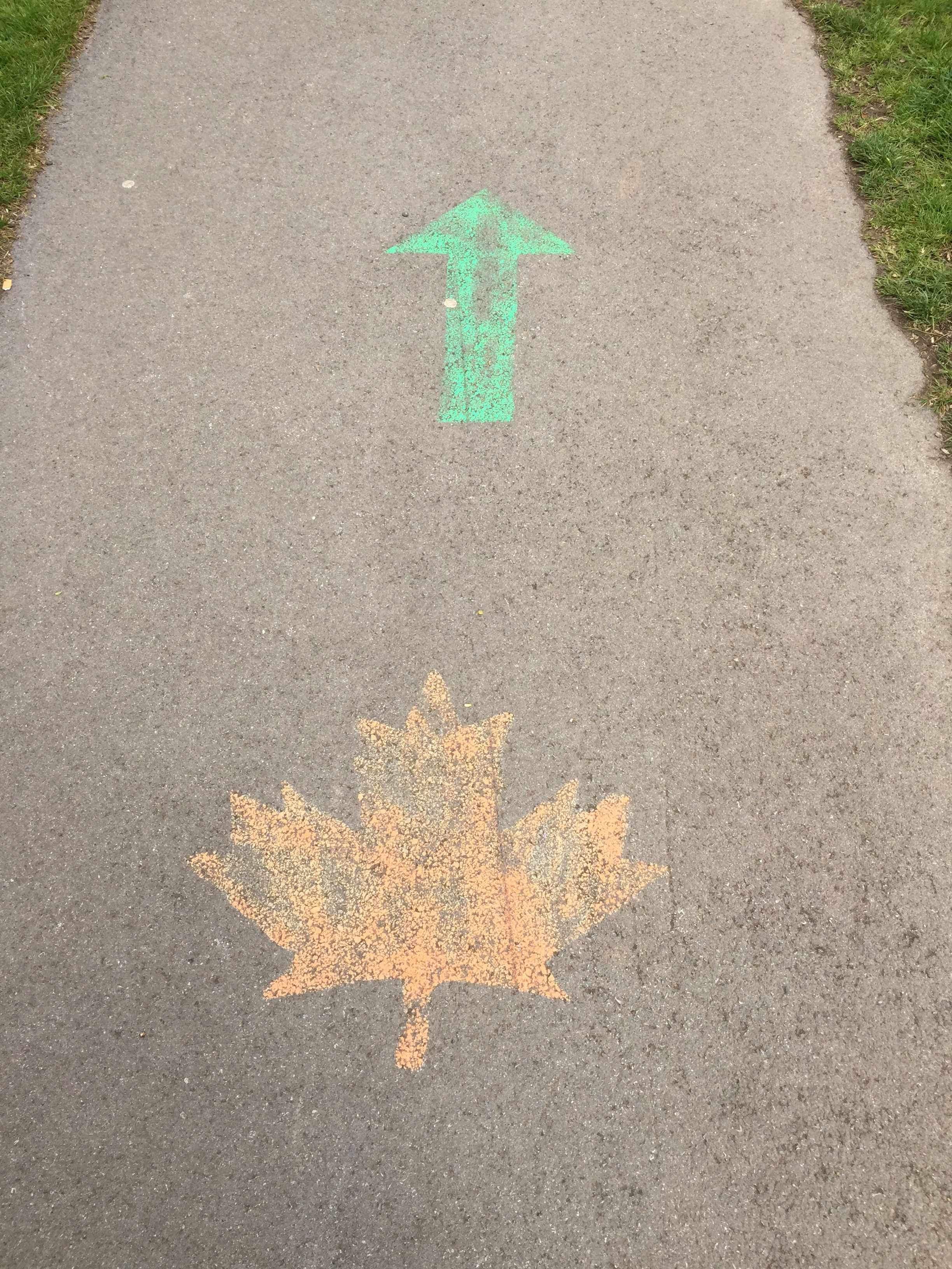 Chalk direction on sidewalk to memorial